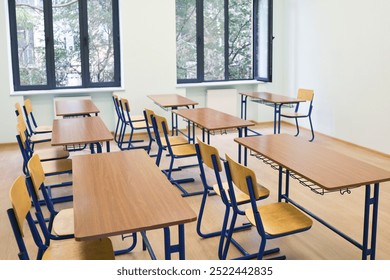 Empty classroom with wooden desks and chairs  in   learning environment