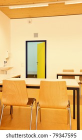 Empty Classroom With Yellow Door Open