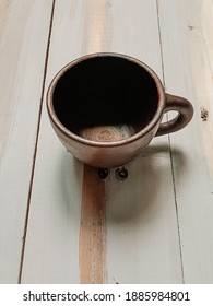 Empty clay cup on the rustic wooden table
