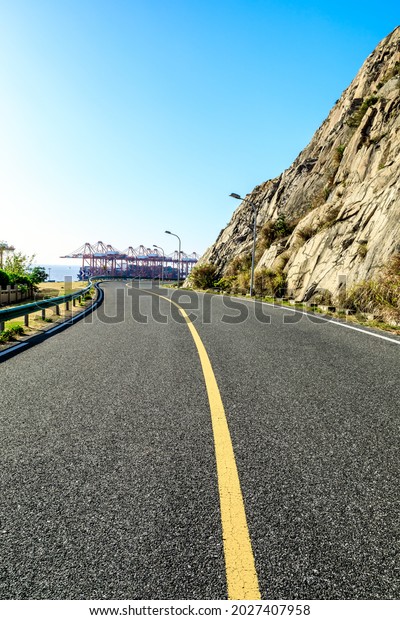 Empty and clean asphalt roads and pier industrial\
landscape in summer, Asia