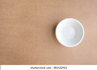 Empty Clean Bowl Isolated On Brown Old Paper Background, Top View