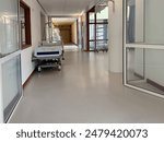 Empty clean hospital hallway with glass doors