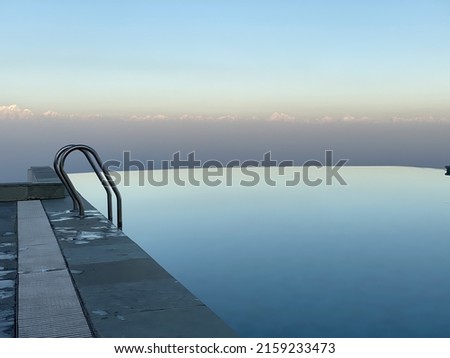 An empty clean swimming pool with the view of mountains in the background
