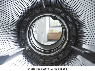 Empty clean washing machine drum, view from the inside of the appliance