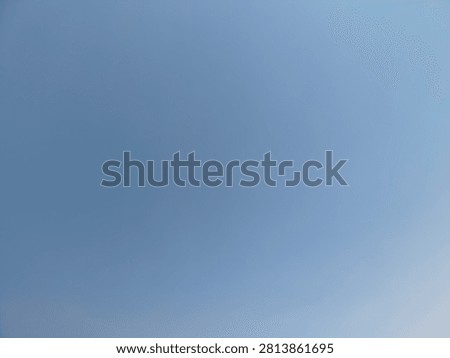 Empty clear blue sky providing a tranquil backdrop and substantial blank copy space, ideal for various graphical overlays, text, or minimalist design elements
