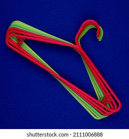Empty clothes hanger, multicolored plastic coat hangers. Shop and wardrobe accessories. Fashionable shopping bright concept