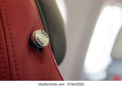 Empty Clothes Hanger On Seat In A Flying Aircraft. Coat Hanger On The Airplane Seat Close Up.