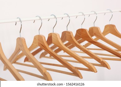 Empty Clothes Hangers On A Wardrobe Rack On A Light Background.
