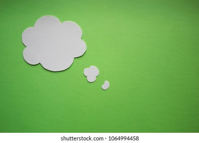 Empty cloud.	Blank speech bubble on green paper background.	