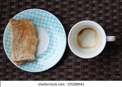 Empty Coffee Cup And Half Toast 