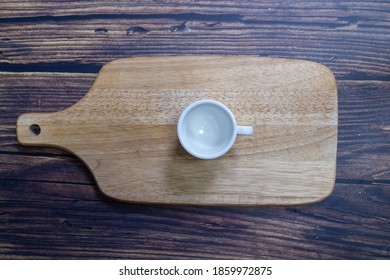Empty coffee cup on serving board, taken from above, top view.
