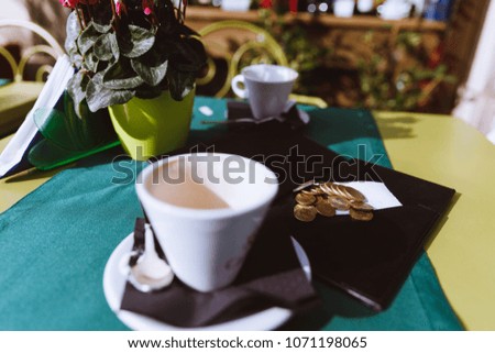 Empty coffee cup on a table. Check please. Coffee and check.