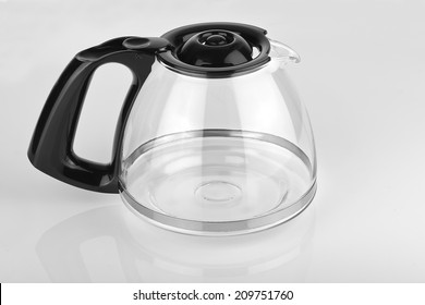 A Empty Coffee Pot On A Glossy White Table