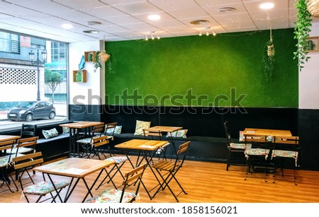 Empty coffee shop interior with artificial grass wall
