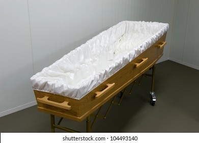 An Empty Coffin With White Sheet In A Morgue