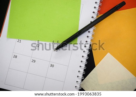 Empty coloful sticky note monthly calendar on black background. So you can put your text here