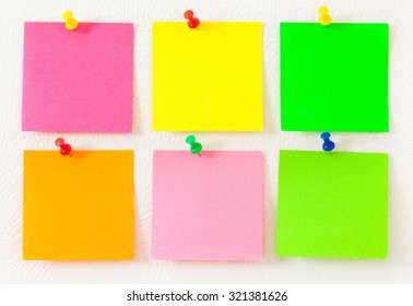 Empty Colorful Post Its On The Wall With Push Pins.