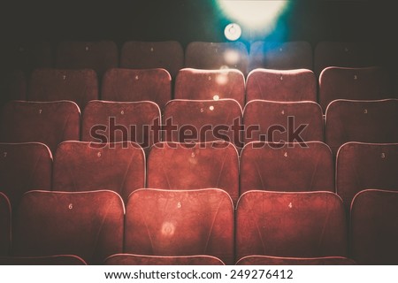 Empty comfortable red seats with numbers in cinema