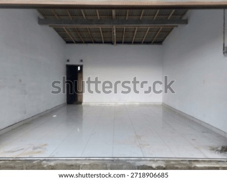 Empty commercial space interior with tiled floor and white walls. Clean vacant shop or garage room suitable for business, warehouse, studio, renovation, or rental concept background.