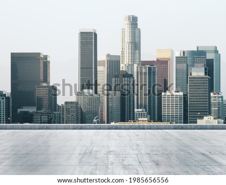 Empty concrete dirty rooftop on the background of a beautiful Los Angeles city skyline at daytime, mock up