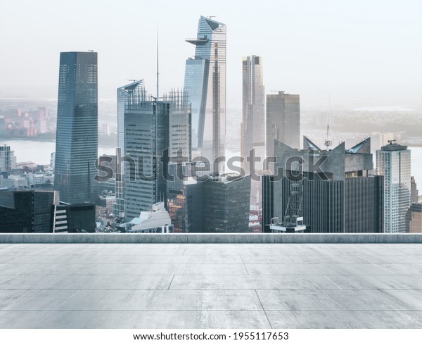 Empty concrete dirty\
rooftop on the background of a beautiful New York city skyline at\
sunset, mock up