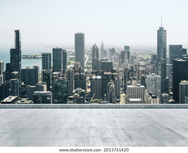 Empty concrete dirty\
rooftop on the background of a beautiful Chicago city skyline at\
daytime, mock up