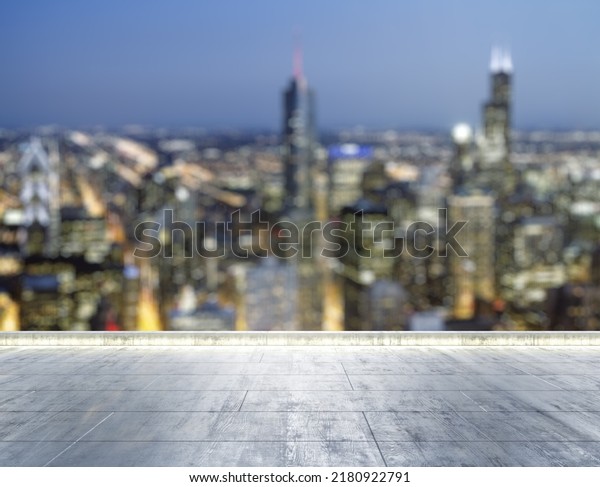 Empty concrete\
dirty rooftop on the background of a beautiful blurry Chicago city\
skyline at night, mock up