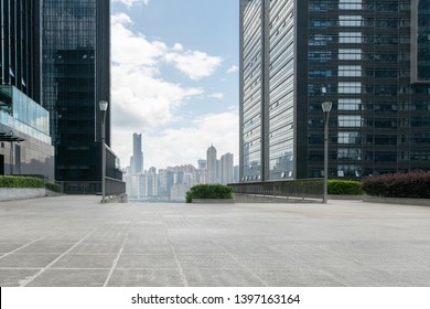 Empty concrete ground floor with modern cityscape and office buildings