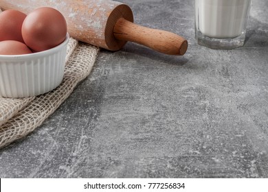 Empty Concrete Kitchen Counter, Eggs In A White Bowl, Poppy Seed Roller, A Glass Of Milk And Jute