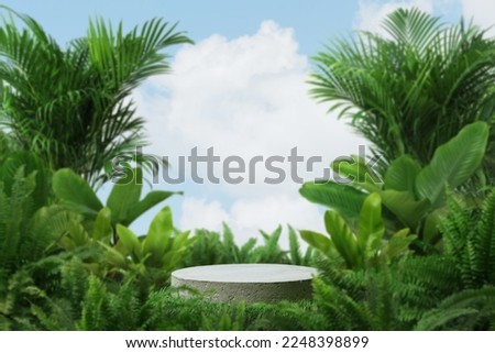 empty concrete podium on green grass with tropical forest plant blur cloud blue sky background with space.organic healthy product present natural placement pedestal display,spring and summer concept.