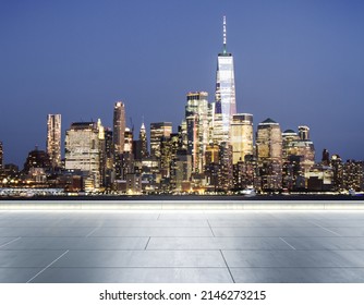 Empty concrete rooftop on the background of a beautiful blurry New York city skyline at evening, mockup