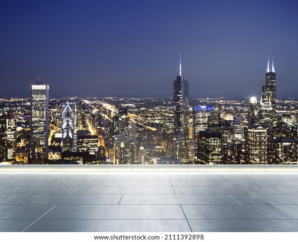 Empty concrete rooftop\
on the background of a beautiful blurry Chicago city skyline at\
evening, mock up
