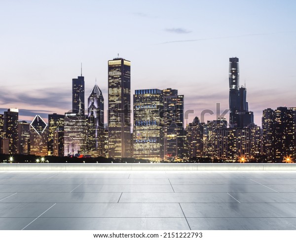 Empty concrete rooftop\
on the background of a beautiful blurry Chicago city skyline at\
twilight, mock up