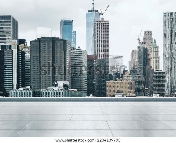 Empty concrete rooftop on the\
background of a beautiful New York city skyline at sunset, mock\
up