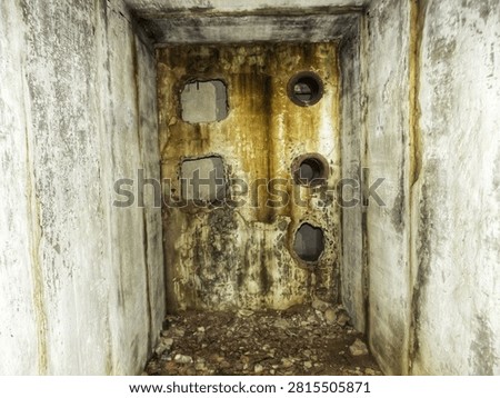 An empty concrete technical corridor inside a factory during communications replacement and overhaul