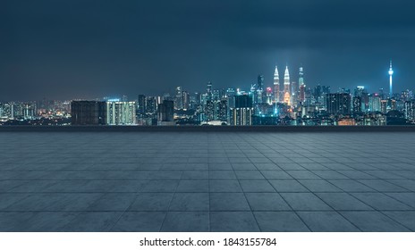 Empty Concrete Tiles Floor With City Skyline Background. Night Scene