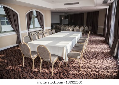 Empty Conference Room With Presentation Screen And Long Table.