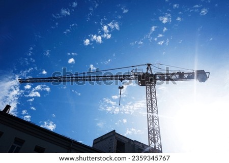 Empty copy space crane background. Yellow paint heavy machinery equipment isolated on blue cloudy sky. Construction site view. Industrial building process.