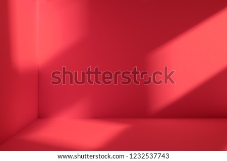 Empty corner of red room with deep window shadow. Minimalistic space concept