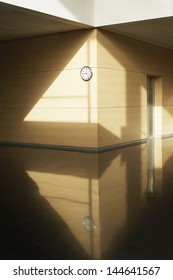 Empty corridor with clock on wall
