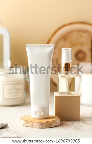  Empty cosmetic tube of cream or gel and serum in a glass jar. Ready for your packaging design. Spa concept, skin care. 