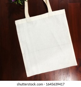 Empty Cotton Tote Bag On The Wooden Table.