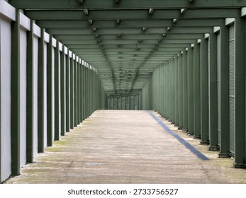 Empty covered walkway with repeating columns and perspective lines, modern architectural corridor with copy space