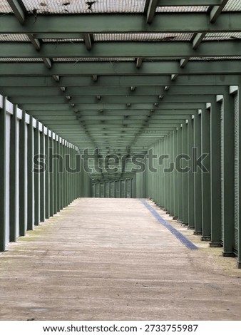 Empty covered walkway with repeating columns and perspective lines, modern architectural corridor with copy space