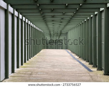 Empty covered walkway with repeating columns and perspective lines, modern architectural corridor with copy space