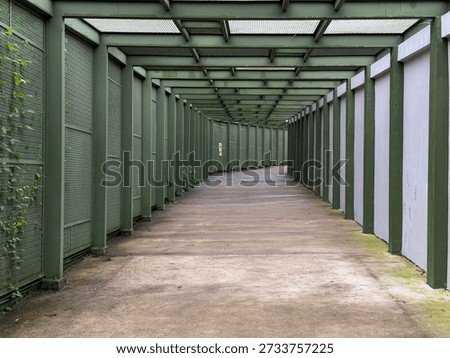 Empty covered walkway with repeating columns and perspective lines, modern architectural corridor with copy space