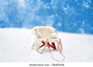 Empty Cozy Wooden Sledge In Winter Park.Kids Sled In Winter Park. Outdoor Active Fun For Family Vacation.