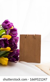 Empty craft mock up paper bag and bouquet of tulips - Shutterstock ID 1669521247