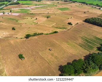 Empty Crop Field Near Rural Village In Asian Country