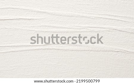 Empty crumpled wet canvas fabric texture copy space wave background. Gray beige pastel color.